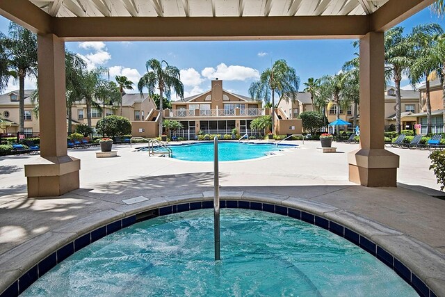 5017 City St Unit 1932, Orlando, FL 32839 - community pool with a residential view, a community hot tub, and a patio area