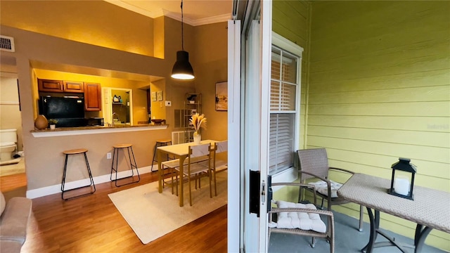 5017 City St Unit 1932, Orlando, FL 32839 - dining room featuring ornamental molding, wood finished floors, and a towering ceiling