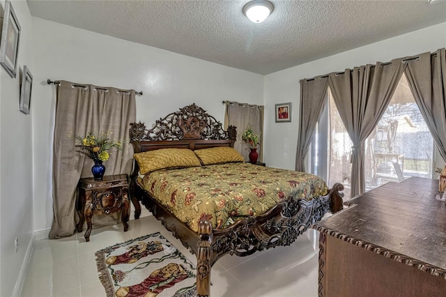 bedroom with baseboards, a textured ceiling, and light tile patterned flooring