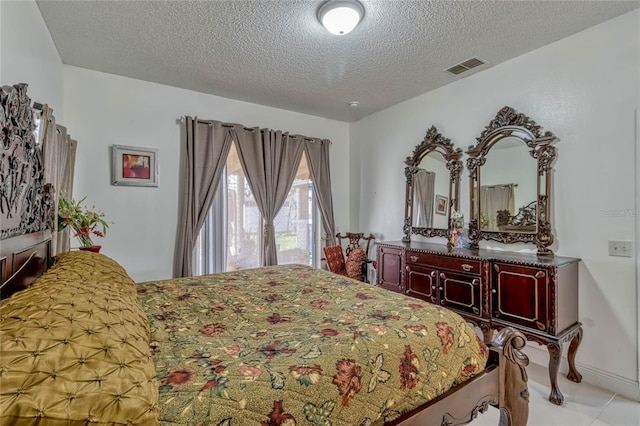 bedroom featuring a textured ceiling and visible vents