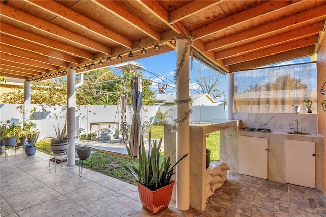 view of patio featuring a fenced backyard and a sink