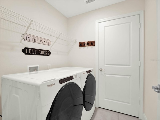 laundry area featuring light tile patterned floors, laundry area, visible vents, and washer and dryer