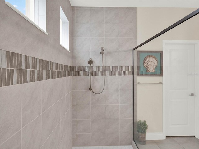 full bathroom with a walk in shower, tile patterned flooring, and a healthy amount of sunlight