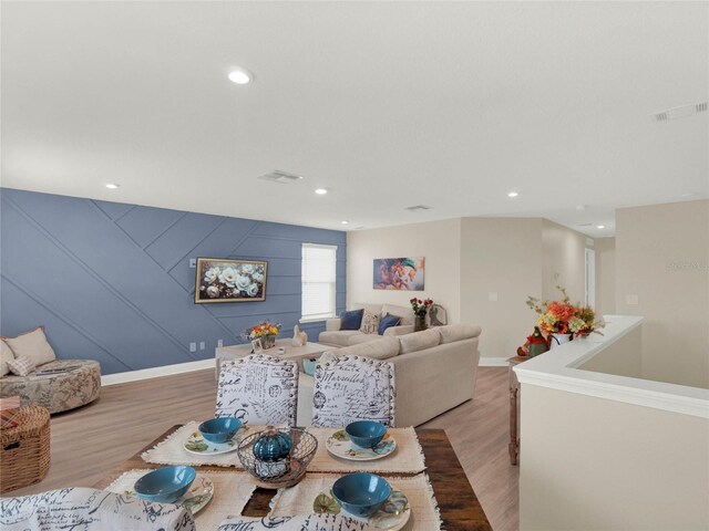 dining room with light wood-type flooring, visible vents, and recessed lighting