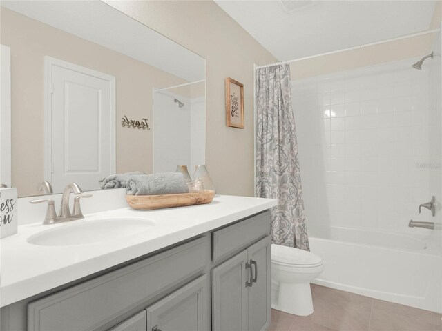 bathroom featuring shower / tub combo, vanity, toilet, and tile patterned floors