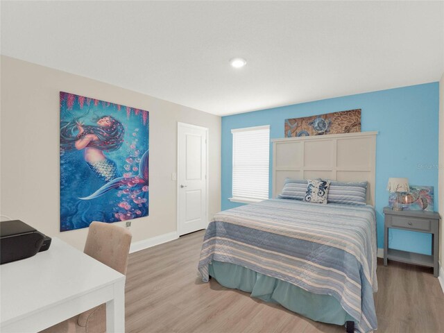 bedroom featuring baseboards and wood finished floors