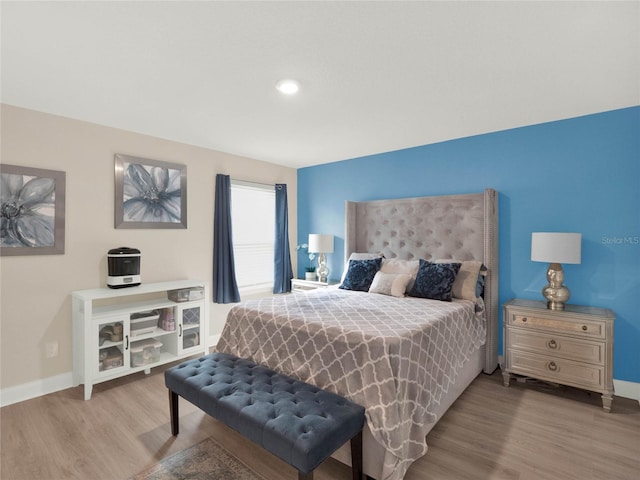 bedroom with baseboards and light wood-style floors