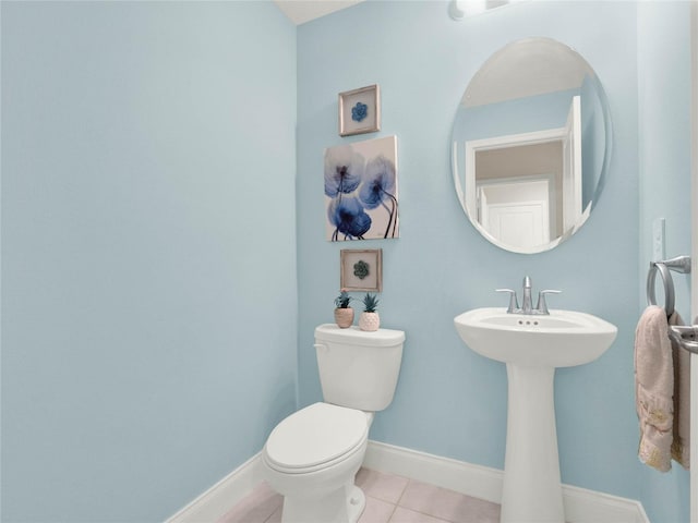 bathroom featuring toilet, baseboards, and tile patterned floors