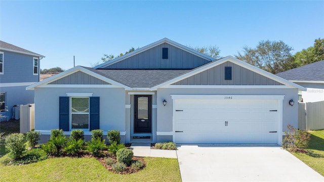 ranch-style house with an attached garage, a shingled roof, a front lawn, and concrete driveway