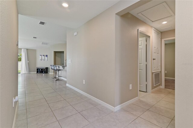 1546 Park Leah Cir, Apopka, FL 32712 - hall featuring light tile patterned floors, attic access, visible vents, and baseboards
