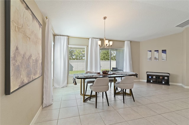 1546 Park Leah Cir, Apopka, FL 32712 - dining room with light tile patterned floors, a textured ceiling, baseboards, and a notable chandelier