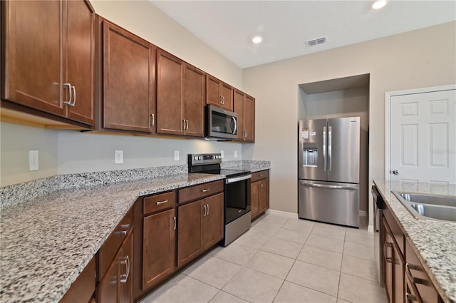 1546 Park Leah Cir, Apopka, FL 32712 - kitchen featuring light tile patterned floors, light stone counters, recessed lighting, stainless steel appliances, and visible vents