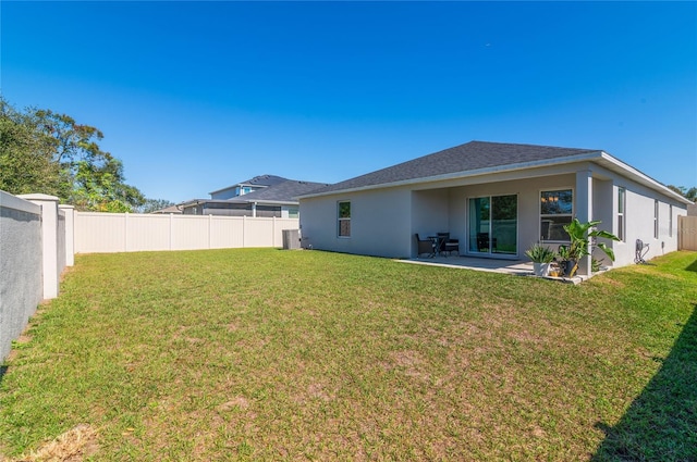 1546 Park Leah Cir, Apopka, FL 32712 - rear view of property with a fenced backyard, a lawn, and stucco siding