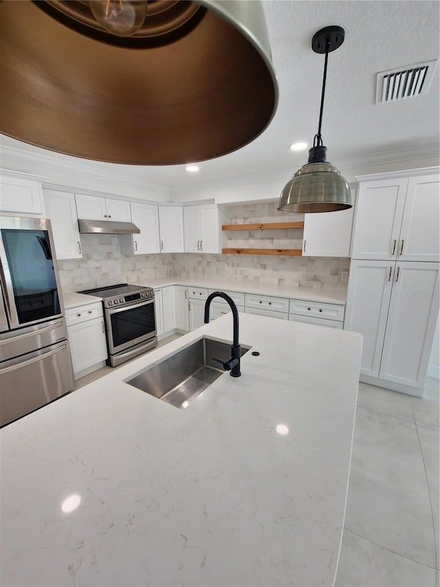 kitchen featuring visible vents, stainless steel appliances, white cabinetry, open shelves, and a sink