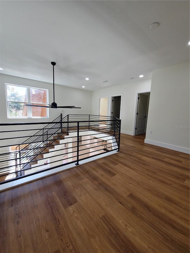 unfurnished room featuring recessed lighting, baseboards, and wood finished floors