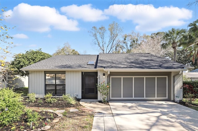 single story home featuring a garage, concrete driveway, and a shingled roof