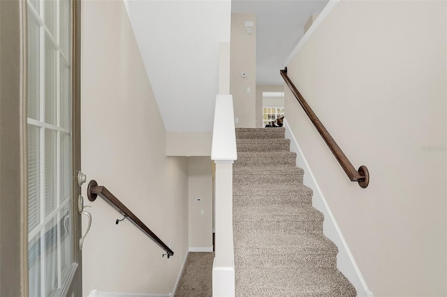 staircase with carpet and baseboards