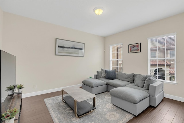 living area featuring dark wood-type flooring and baseboards