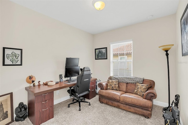 home office with light carpet and baseboards