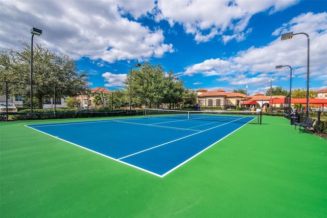 view of tennis court with fence