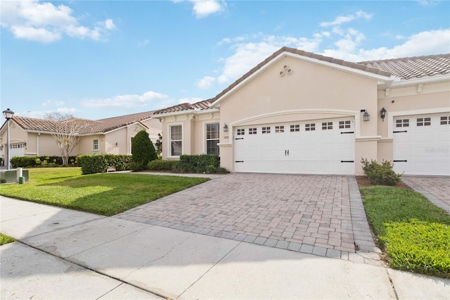 view of front of house featuring a garage and a front lawn