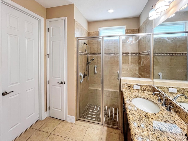 bathroom featuring vanity, tile patterned flooring, and an enclosed shower