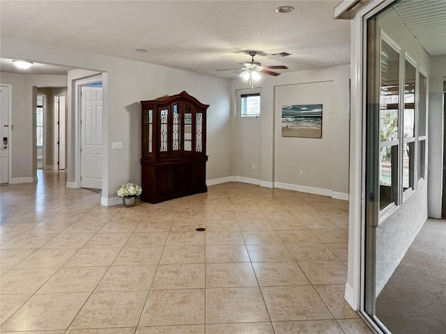 entryway featuring light tile patterned flooring and ceiling fan