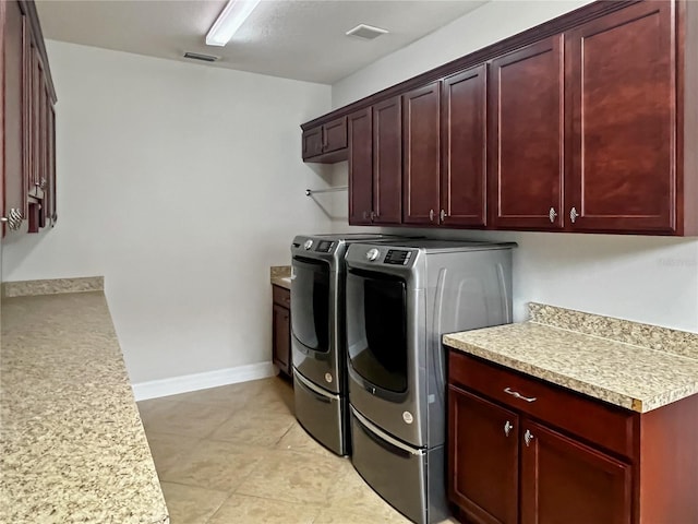 washroom featuring cabinets and washing machine and clothes dryer