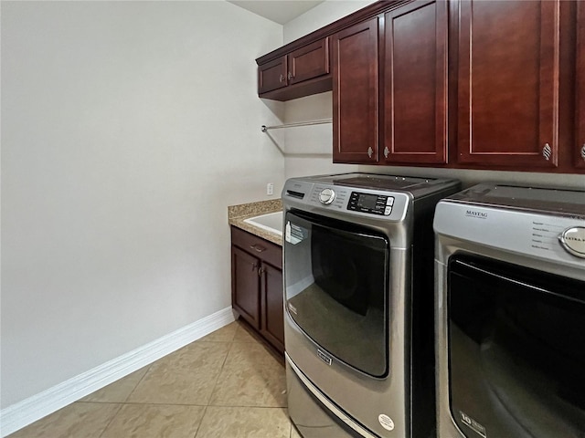 washroom with cabinets, light tile patterned floors, and separate washer and dryer