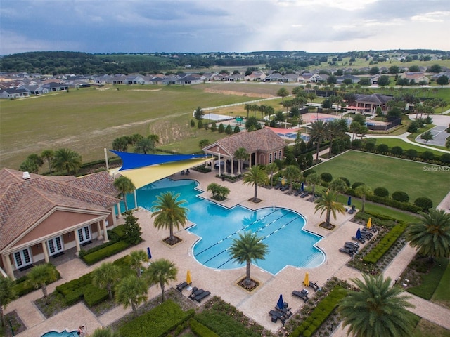 birds eye view of property featuring a patio and a community pool