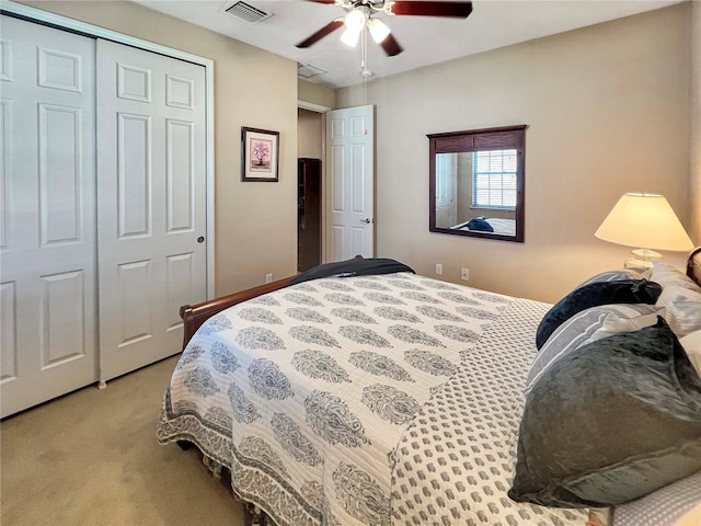 bedroom with a closet, ceiling fan, and light colored carpet