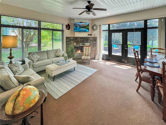 living room with carpet, french doors, a fireplace, wood ceiling, and ceiling fan