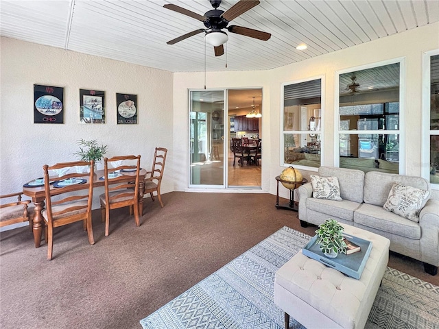 sunroom featuring ceiling fan and wooden ceiling