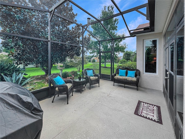 view of patio with area for grilling and a lanai