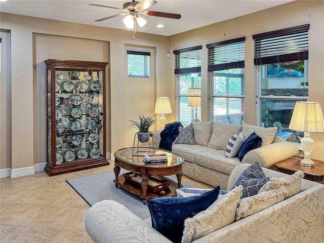 living room with light tile patterned floors and ceiling fan