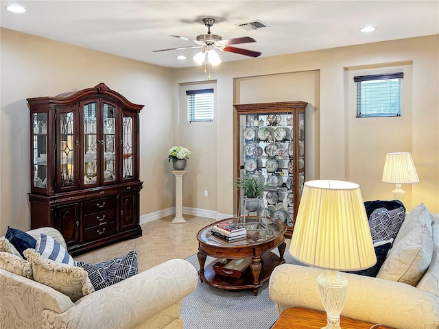 living room with ceiling fan and light tile patterned floors