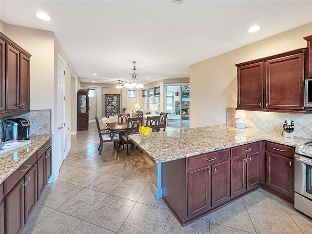 kitchen with kitchen peninsula, hanging light fixtures, and stainless steel appliances