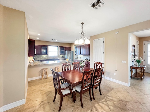 tiled dining room with sink