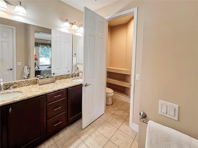 bathroom with vanity, tile patterned flooring, and toilet