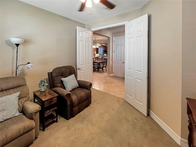 sitting room featuring light tile patterned flooring and ceiling fan