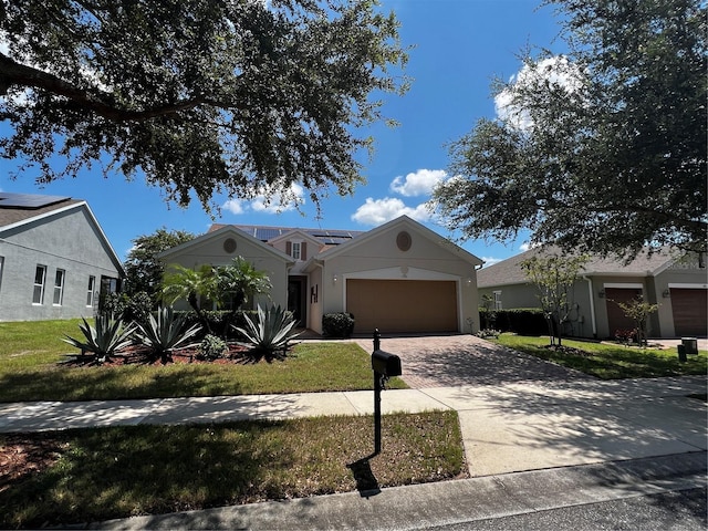 single story home with a garage and a front lawn