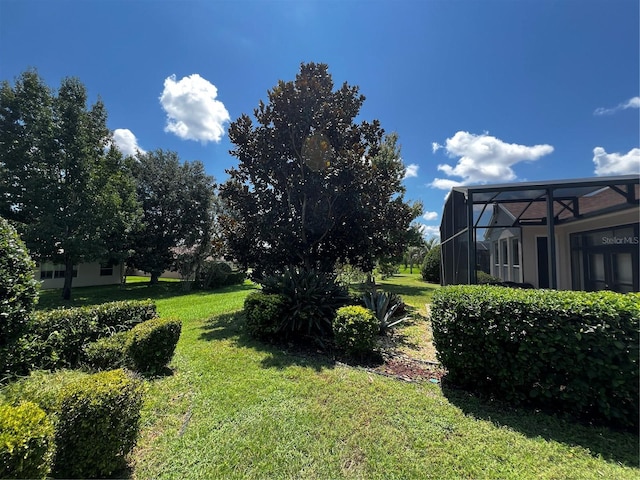 view of yard featuring a lanai