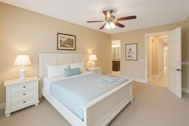 172 Balmy Coast Rd, Groveland, FL 34736 - bedroom featuring light colored carpet, connected bathroom, a ceiling fan, and arched walkways