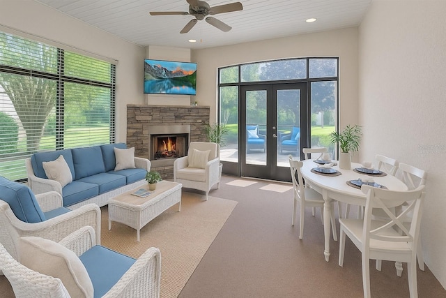 172 Balmy Coast Rd, Groveland, FL 34736 - living room featuring carpet, ceiling fan, french doors, a stone fireplace, and recessed lighting