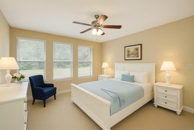 172 Balmy Coast Rd, Groveland, FL 34736 - bedroom featuring light colored carpet, multiple windows, and a ceiling fan