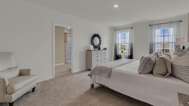 bedroom featuring light colored carpet