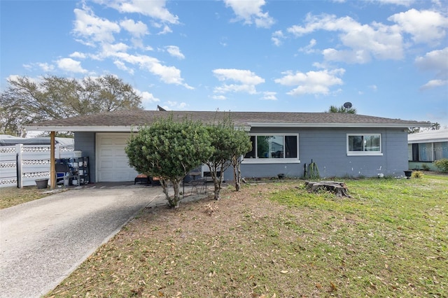 single story home featuring a garage, a front lawn, and driveway