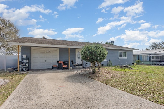 single story home featuring a garage, driveway, and fence