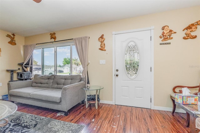 entryway featuring baseboards and wood finished floors