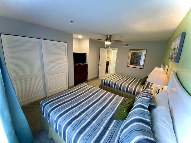 carpeted bedroom with a closet and ceiling fan